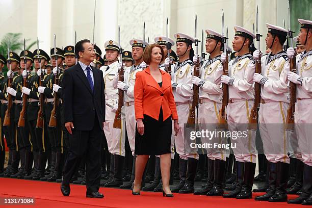 Chinese Premier Wen Jiabao accompanies Australian Prime Minister Julia Gillard to view an honour guard during a welcoming ceremony inside the Great...