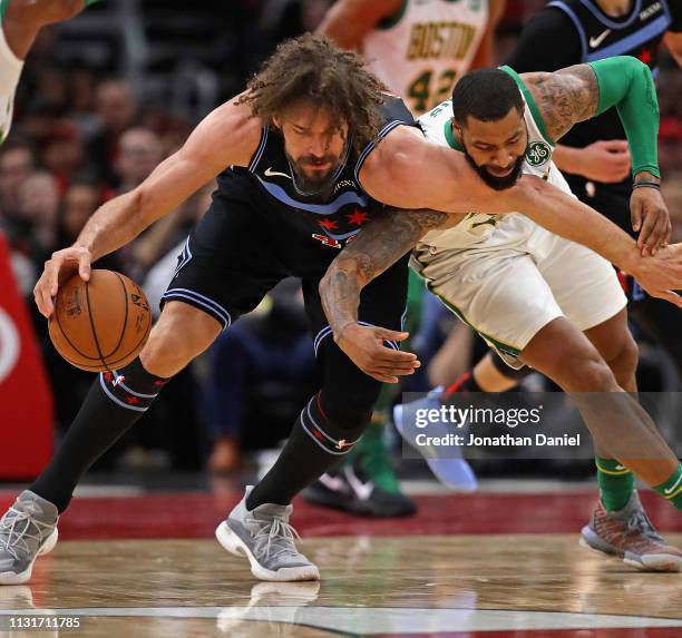 Marcus Morris of the Boston Celtics fouls Robin Lopez of the Chicago Bulls as they battle for the ball at the United Center on February 23, 2019 in...