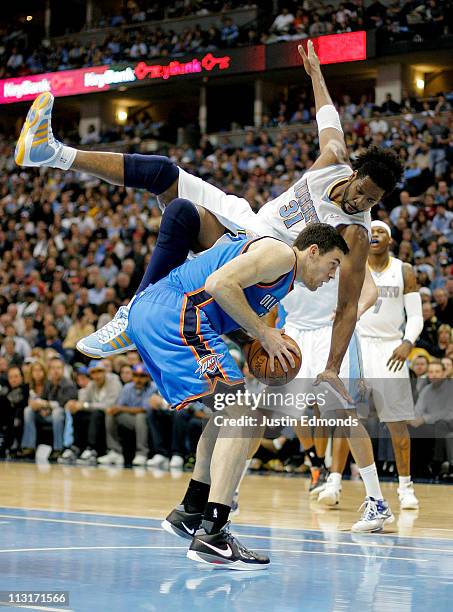 Nene of the Denver Nuggets falls over the back and fouls Nick Collison of the Oklahoma City Thunder in Game Four of the Western Conference...