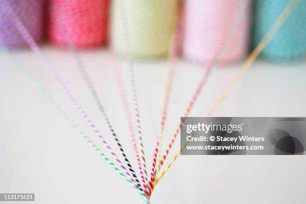 different colored twine twisting together - spool twine stock pictures, royalty-free photos & images