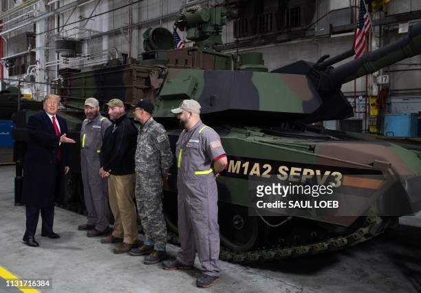 President Donald Trump greets workers as he tours the Lima Army Tank Plant at Joint Systems Manufacturing in Lima, Ohio, March 20, 2019.