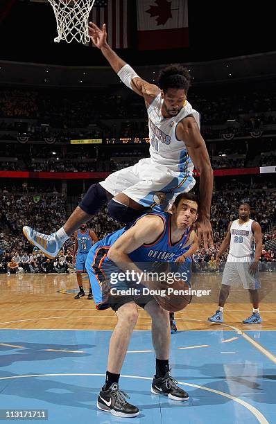 Nick Collison of the Oklahoma City Thunder tries to get off a shot but is fouled by Nene Hilario of the Denver Nuggets in Game Four of the Western...