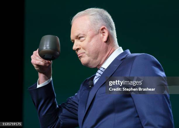 Starbucks CEO Kevin Johnson takes a sip of coffee while speaking during the company's annual shareholders meeting at WAMU Theater, on March 20, 2019...