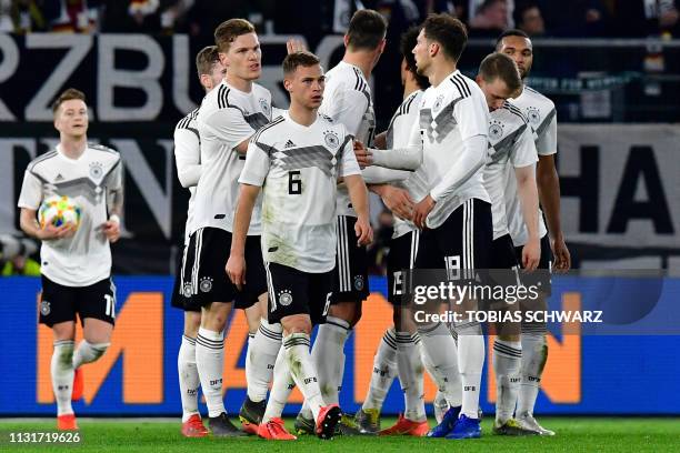 Germany's midfielder Leon Goretzka celebrates scoring the 1-1 equaliser with his team-mates during the friendly football match Germany v Serbia in...