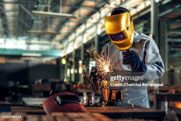 worker welder working welding steel in industry with safety mask safety gloves and safety equipment. worker welding concept. - 溶接する ストックフォトと画像