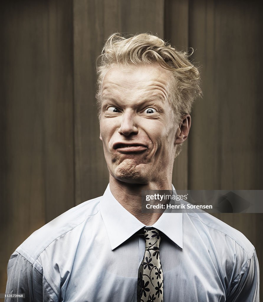 Portrait of grimacing businessman