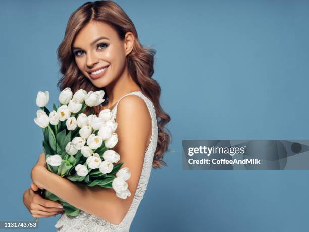 beautiful woman with tulips - bride holding bouquet stock pictures, royalty-free photos & images