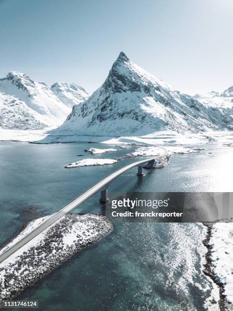 winter view of the bridge at the lofoten islands - norway road stock pictures, royalty-free photos & images