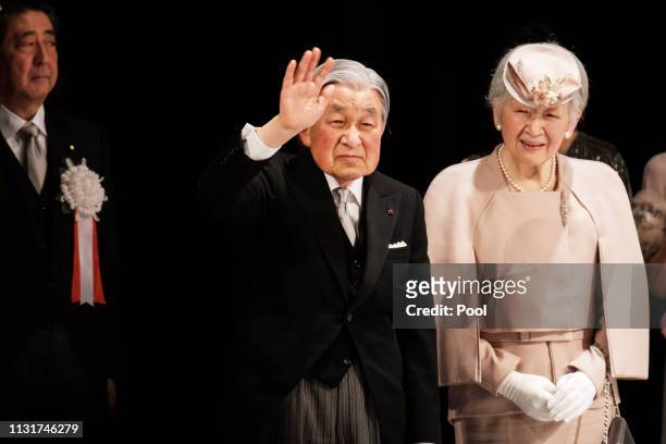 Japan Prime Minister Shinzo Abe stands as Japanese Emperor Akihito and Empress Michiko greet audience after a ceremony to mark the 30th anniversary...