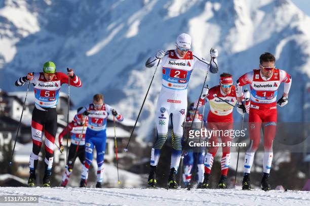 Oskar Svensson of Sweden, Emil Iversen of Norway and Max Hauke of Austria competes in the first semifinal run for the Mens' Cross Country Team Sprint...