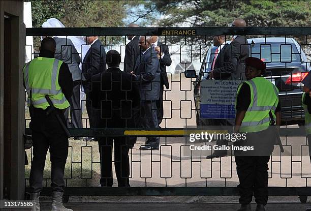 Security personnel surround the bride and her father as they arrive to attend the wedding celebrations for President Jacob Zuma's daughter Duduzile...