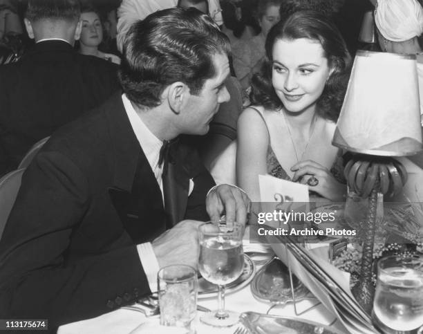 Actor Laurence Olivier and his wife actress Vivien Leigh at a dinner table in the 1940's.