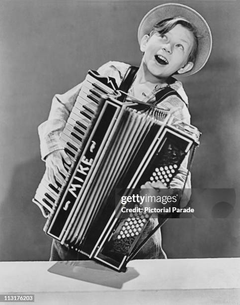 American actor Donald O'Connor playing the accordion, aged 12, in 1938.