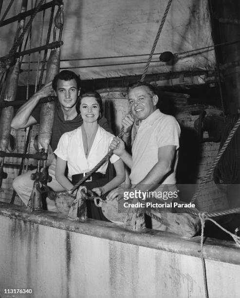 Actor Rock Hudson , actress Cyd Charisse and director Joseph Pevney on board a boat during the filming of 'Twilight For The Gods' in 1958.