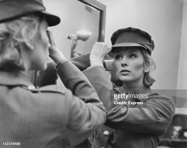 American actress Suzy Parker trying on a costume for the film 'A Circle of Deception' in a Saville Row tailors in London on July 28, 1960.