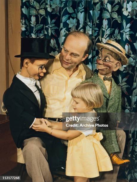 American ventriloquist Edgar Bergen with two dummies, including Charlie McCarthy wearing a tuxedo, and his young daughter Candice Bergen circa 1950.