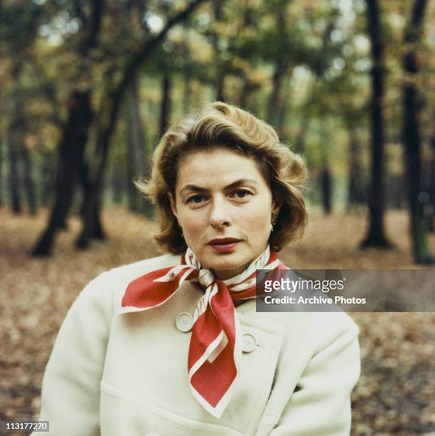 Swedish actress Ingrid Bergman sitting outside in the woods circa 1960.
