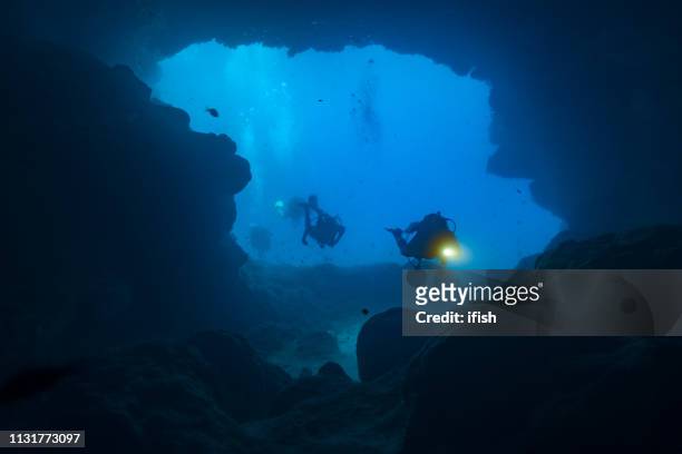 cave divers exploring the santa maria caves, comino, malta - caving stock pictures, royalty-free photos & images