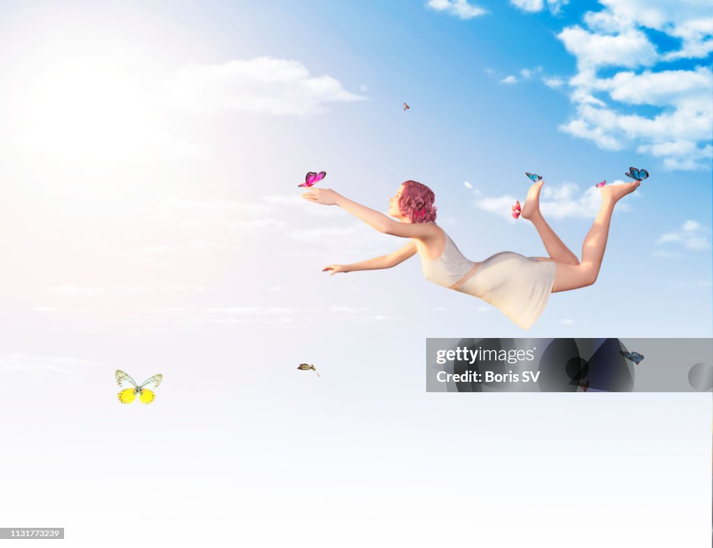 Woman levitating with butterflies