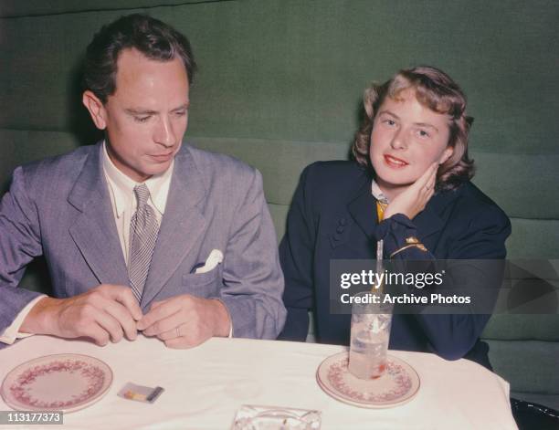 Swedish actress Ingrid Bergman and her husband doctor Petter Lindstrom at a dinner table shortly after their arrival in the United States circa 1940.