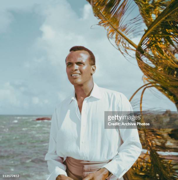American actor and singer Harry Belafonte on a beach, circa 1957.