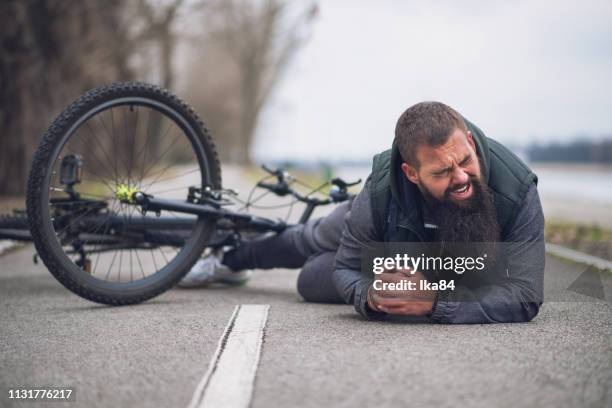 a man fell from a bicycle - bicycle crash stock pictures, royalty-free photos & images