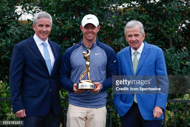 Winner Rory McIlroy of Northern Ireland poses with PGA Tour commissioner Jay Monahan and former PGA Tour commissioner Tim Finchem during the final...
