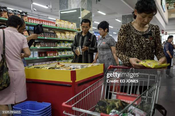 In a photo taken on June 4, 2017 customers shop for North Korean-produced food at the Kwangbok department store supermarket in Pyongyang. - The North...