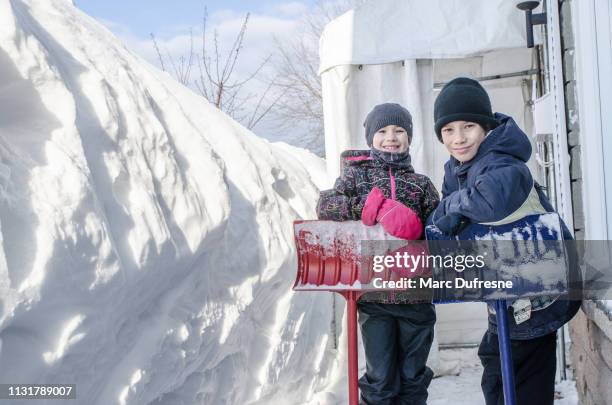 kids resting after snow shoveling - huge task stock pictures, royalty-free photos & images