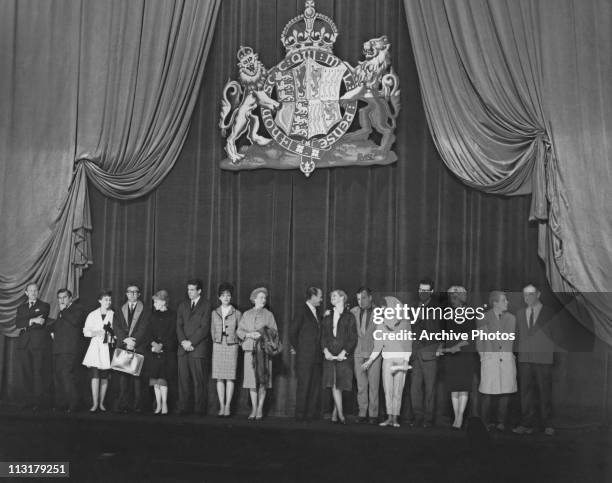 Line up of film stars on stage at the Odeon Leicester Square in London, England before the Royal Film Performance in February 1961. The line up...