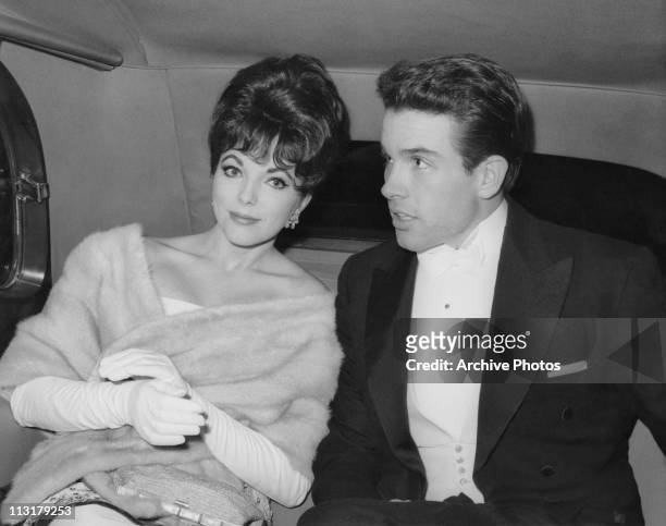 British actress Joan Collins, wearing a fur wrap, with American actor Warren Beatty in the back of a limousine circa 1961.