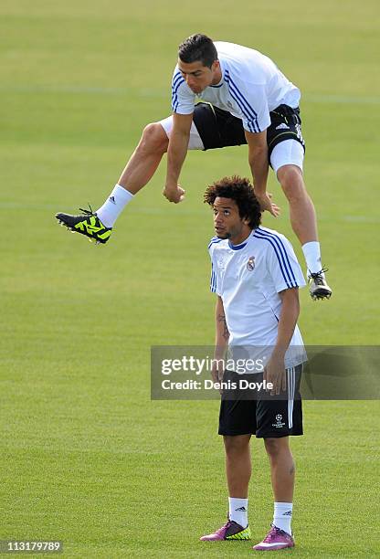 Cristiano Ronaldo of Real Madrid jumps over Marcelo during a training session at Valdebebas training ground ahead of their UEFA Champions League...