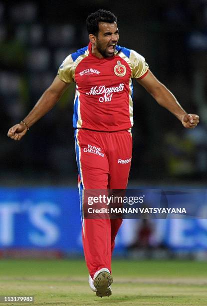 PACKAGERoyal Challengers Bangalore fastbowler Zaheer Khan celebrates after taking the wicket of Delhi Daredevils cricketer David Warner during the...
