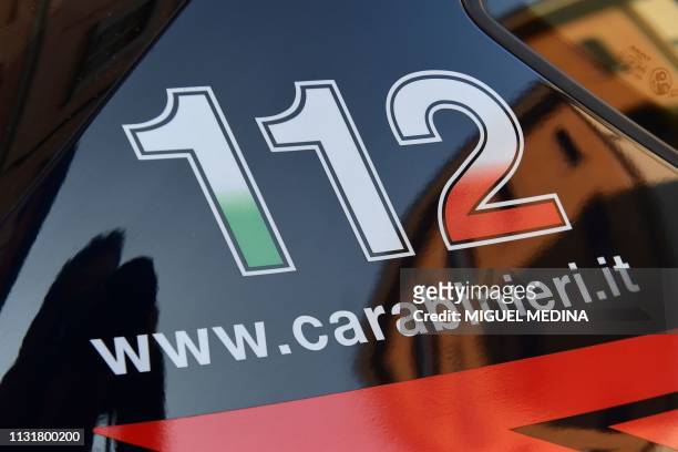 The 112 telephone number for emergency services is pictured on a car of the Italian Carabinieri police on March 21, 2019 in Crema, east of Milan.