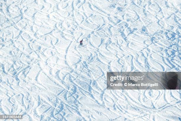 skier off-track skiing on a ski slope - downhill skiing stock pictures, royalty-free photos & images