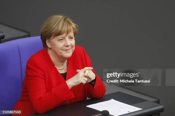 German Chancellor Angela Merkel sit after giving a government declaration at the Bundestag before traveling to Brussels for a summit of European...