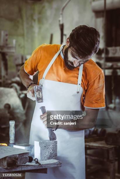 young man engraving stone - sculptor stock pictures, royalty-free photos & images