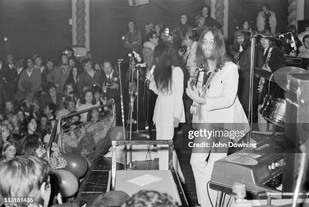 John Lennon and Yoko Ono performing with the Plastic Ono Band at the Lyceum Ballroom, London, 15th December 1969. Guitarists Eric Clapton and George...