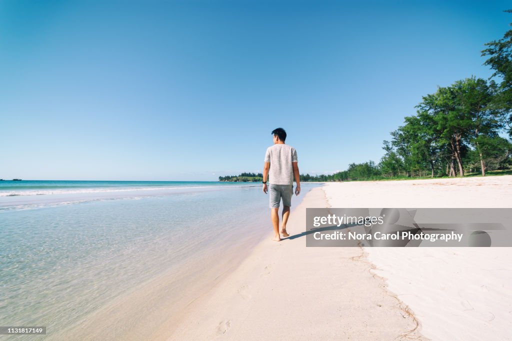 Man Strolling at Simpang Mengayau Tip of Borneo Beach