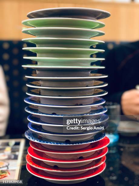 stack of empty sushi plates - sushi plate stock pictures, royalty-free photos & images