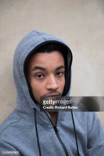 portrait of a mixed race teenager - hoodie boy stock pictures, royalty-free photos & images