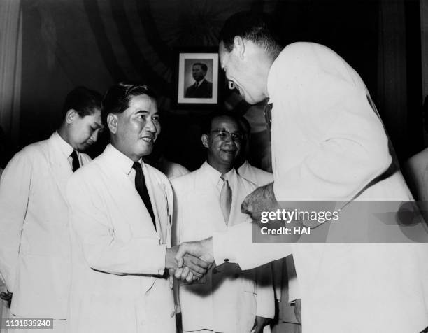 Picture taken on October 26, 1955 at Saigon showing President Ngo Dinh Diem receiving the congratulation of American Ambassador George Frederik...