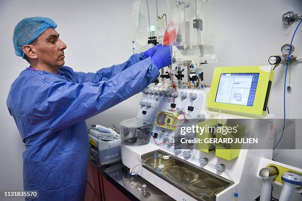 Prodigy Bioreactor A lab tech handles a CliniMACS Prodigy automated device used for cell ...