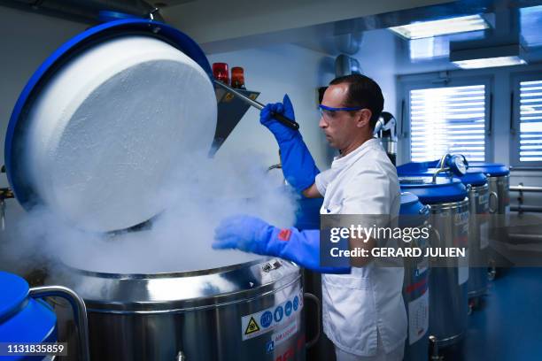 Lab technician opens a cryogenic container with a blood bags in it on March 12, 2019 at the Paoli-Calmettes Institute overall cancer care centre in...