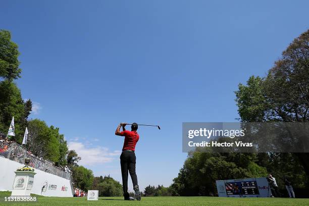 Tiger Woods of the United States plays his shot from the first tee during the final round of World Golf Championships-Mexico Championship at Club de...