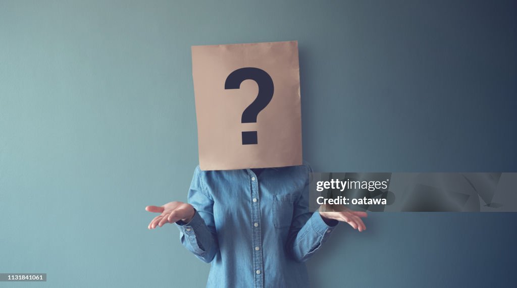 Woman has Confused, Thinking, Question Mark Icon on Paper Bag, copy space.