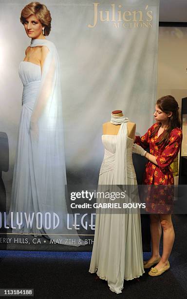 Julien's Auctions employee installs a dress of Lady Diana, Princess of Wales, in Beverly Hills, California on April 26, 2011. Dresses of Lady Diana...