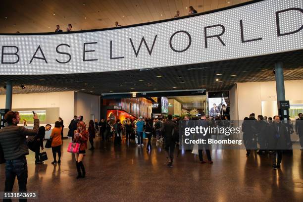 Visitors attend the day two of the 2019 Baselworld luxury watch and jewellery fair in Basel, Switzerland, on Thursday, March 21, 2019. The organizers...