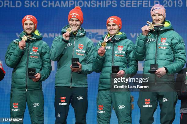 Gold medalists Markus Eisenbichler, Karl Geiger, Richard Freitag and Stephan Leyhe of Germany pose with the medals during the medal ceremony for the...