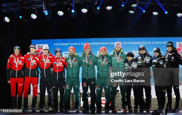 Silver medalists Philipp Aschenwald, Michael Haybock, Stefan Kraft and Daniel Huber of Austria, gold medalists Markus Eisenbichler, Karl Geiger,...